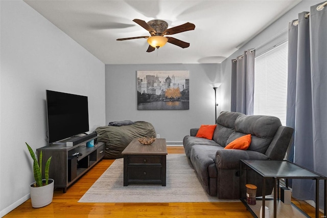 living room featuring ceiling fan and light hardwood / wood-style flooring