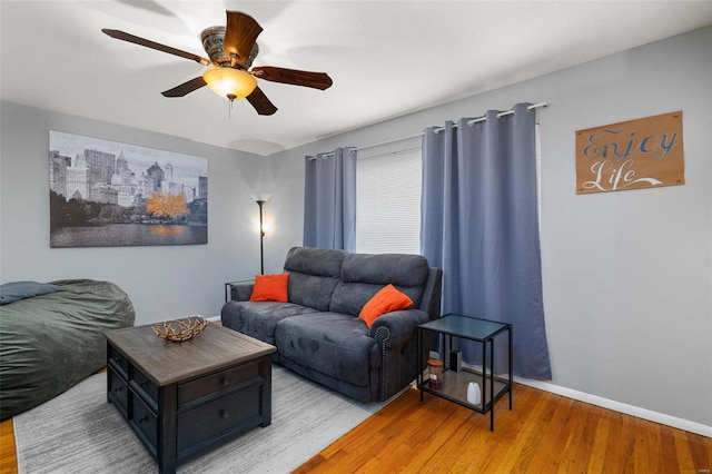 living room featuring ceiling fan and light wood-type flooring