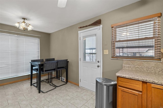 dining room featuring light tile patterned floors and a chandelier