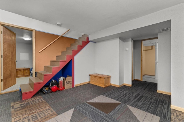 basement with dark colored carpet