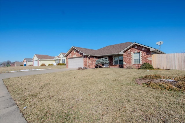 ranch-style home with a garage and a front lawn