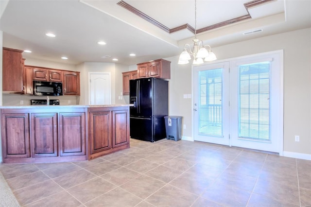 kitchen with a tray ceiling, black fridge with ice dispenser, decorative light fixtures, and crown molding