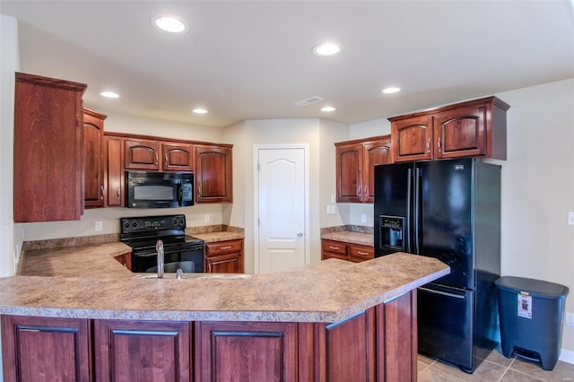 kitchen with light tile patterned floors, black appliances, and kitchen peninsula