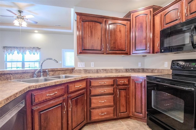 kitchen featuring sink, ceiling fan, black appliances, light tile patterned flooring, and a raised ceiling