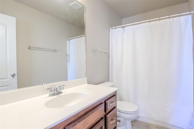 bathroom with vanity, tile patterned flooring, and toilet