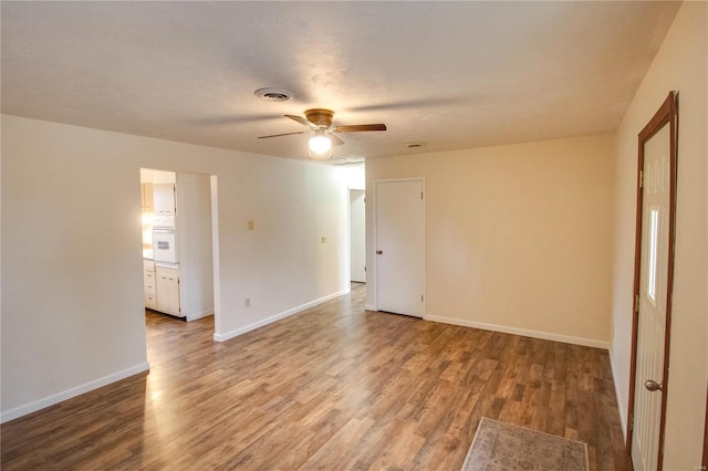 unfurnished room with ceiling fan and wood-type flooring