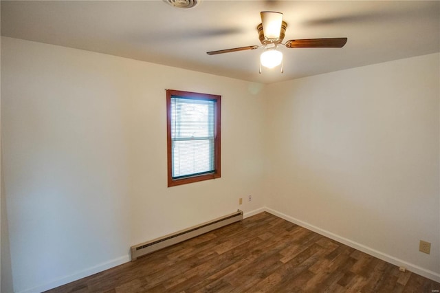 spare room featuring a baseboard heating unit, dark wood-type flooring, and ceiling fan