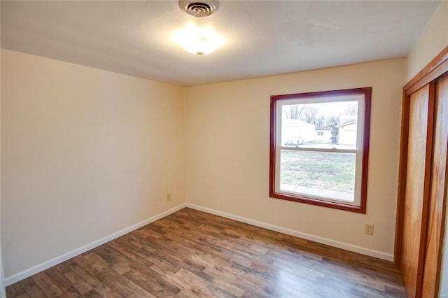 unfurnished room with hardwood / wood-style flooring