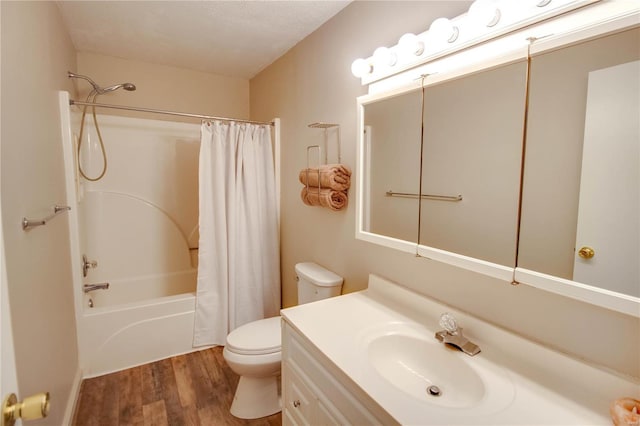 full bathroom featuring hardwood / wood-style flooring, shower / bath combo, vanity, and toilet