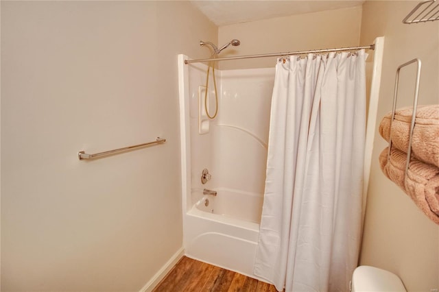 bathroom featuring hardwood / wood-style floors and shower / bath combo with shower curtain