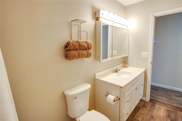 bathroom featuring hardwood / wood-style flooring, vanity, and toilet