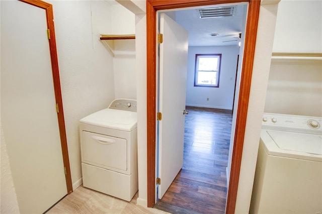 laundry room with light hardwood / wood-style flooring, washer and clothes dryer, and ceiling fan