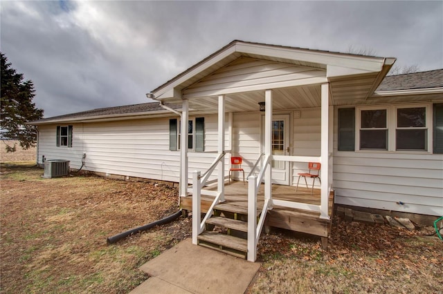 view of front of home with cooling unit and a porch