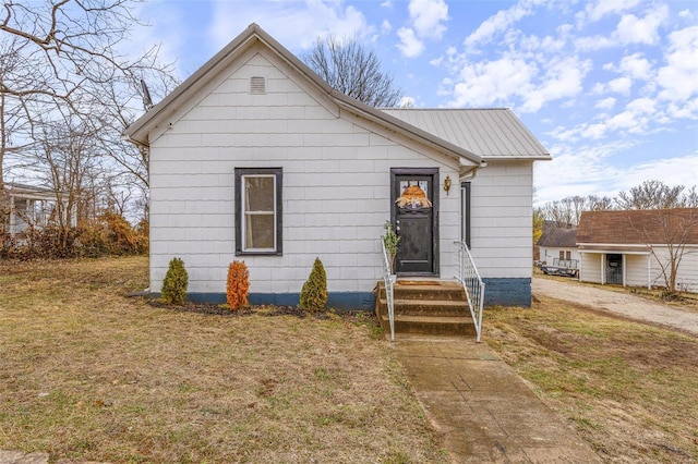 bungalow-style home with a front lawn