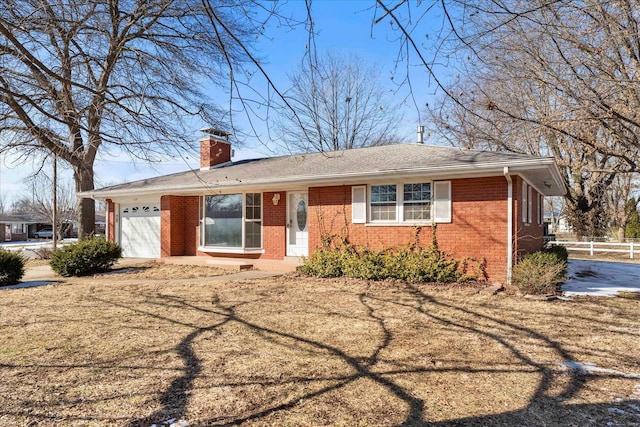 ranch-style home with a garage and a front lawn