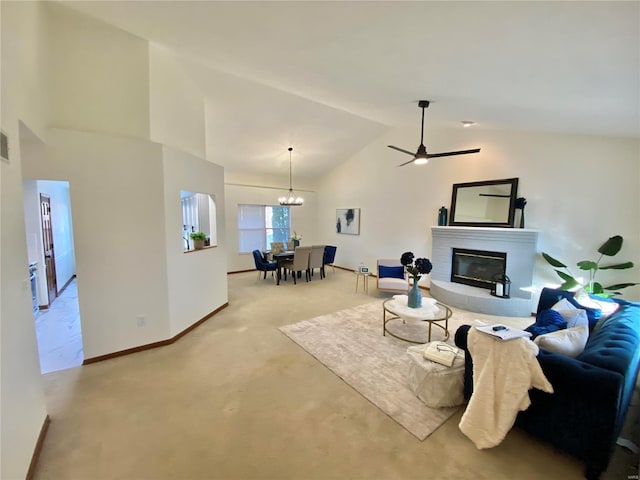 living room with high vaulted ceiling, carpet, and a chandelier