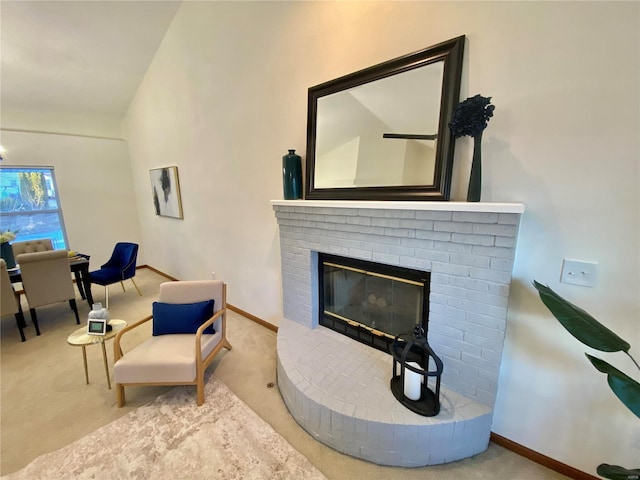 living area featuring a brick fireplace and carpet flooring