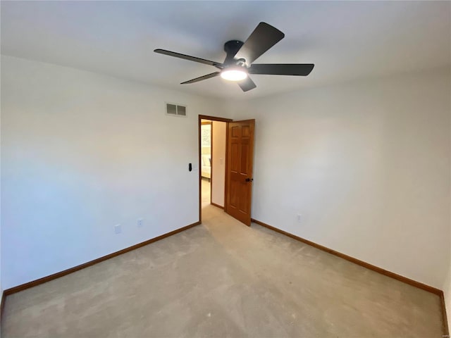 spare room featuring ceiling fan and light carpet