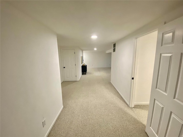 hallway featuring light carpet