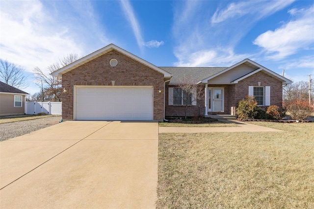 single story home with a garage and a front yard