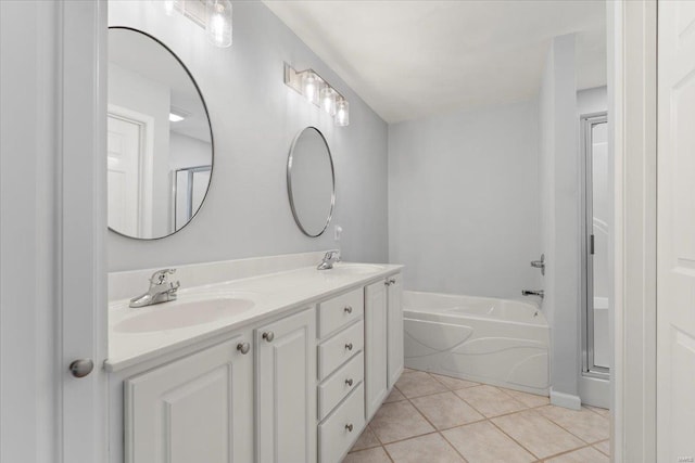 bathroom featuring tile patterned flooring, vanity, and a tub