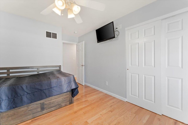 bedroom with a closet, ceiling fan, and light wood-type flooring