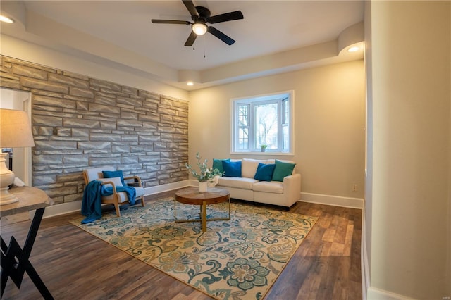 living room with dark wood-type flooring and ceiling fan