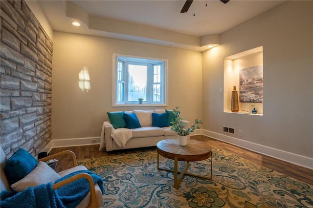 living room with wood-type flooring and ceiling fan