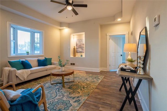 living room with ceiling fan and dark hardwood / wood-style floors