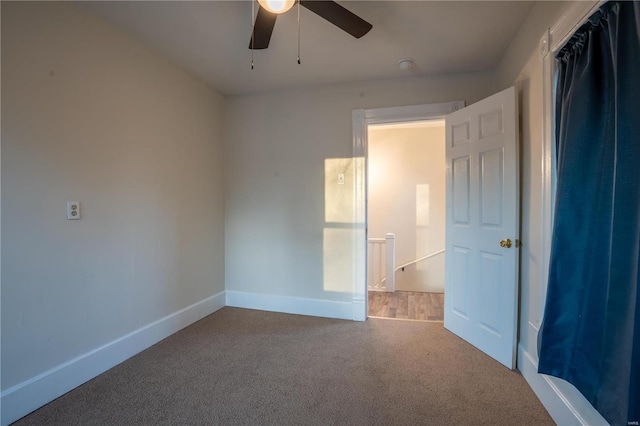 unfurnished bedroom featuring ceiling fan and carpet