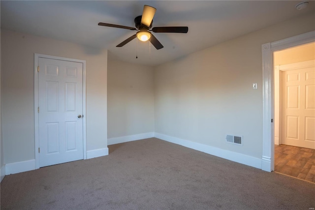 empty room featuring ceiling fan and carpet flooring