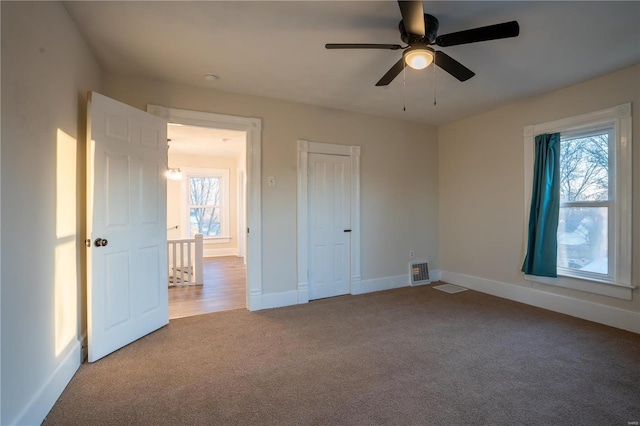 unfurnished bedroom with ceiling fan and carpet floors