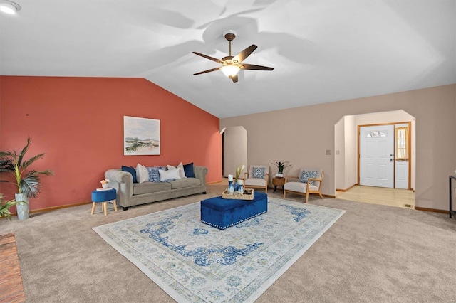 carpeted living room featuring vaulted ceiling and ceiling fan