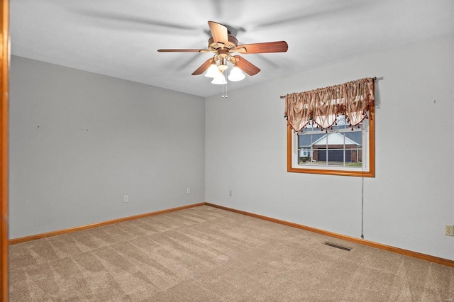 spare room with light colored carpet and ceiling fan