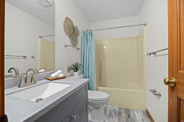 full bathroom with vanity, hardwood / wood-style floors, shower / bath combination with curtain, and toilet