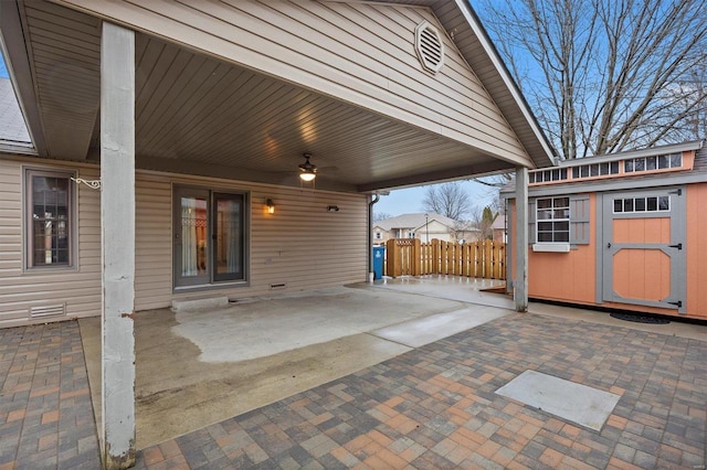 view of patio / terrace featuring ceiling fan and a shed