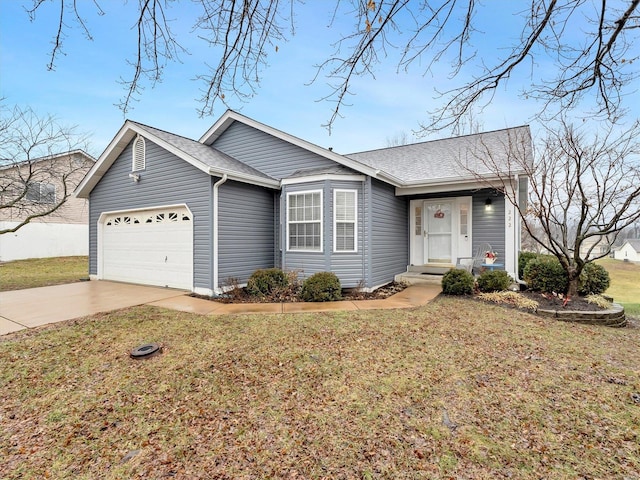 ranch-style house with a garage and a front lawn