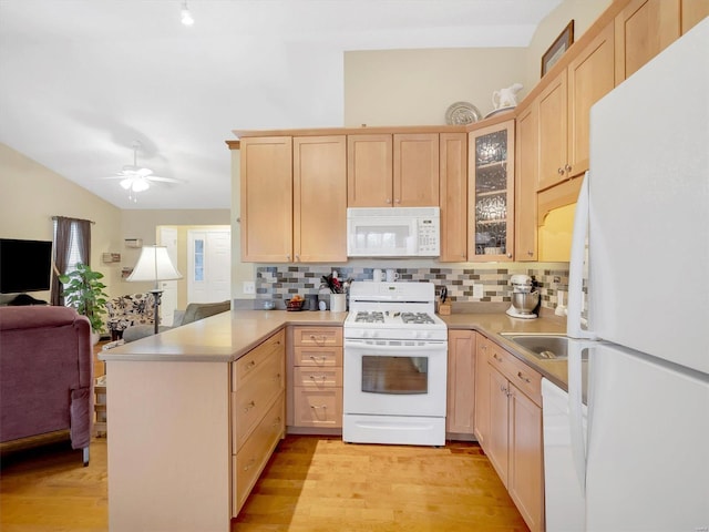 kitchen with light brown cabinetry, backsplash, kitchen peninsula, white appliances, and light hardwood / wood-style flooring