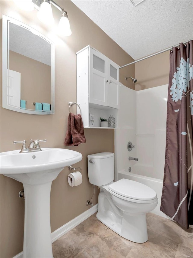 full bathroom with toilet, sink, a textured ceiling, and shower / bath combo