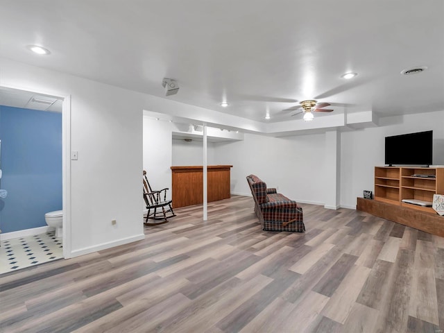 sitting room with hardwood / wood-style floors and ceiling fan