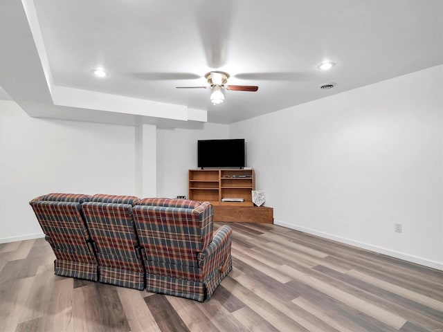 living room with hardwood / wood-style flooring and ceiling fan