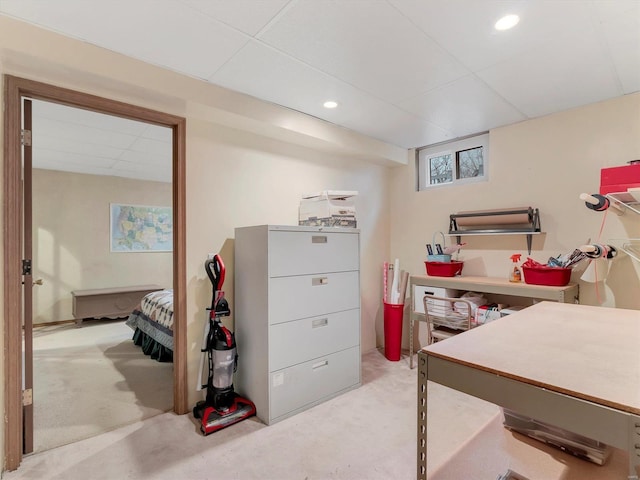 carpeted office space with a drop ceiling