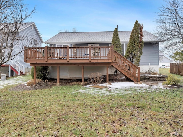 back of house featuring a lawn and a deck