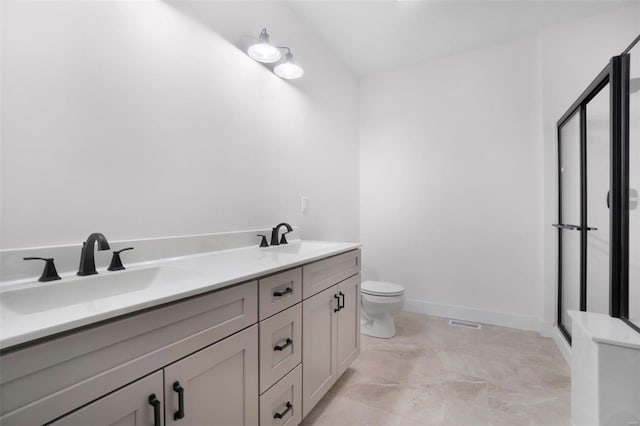 bathroom with vanity, a shower, and toilet