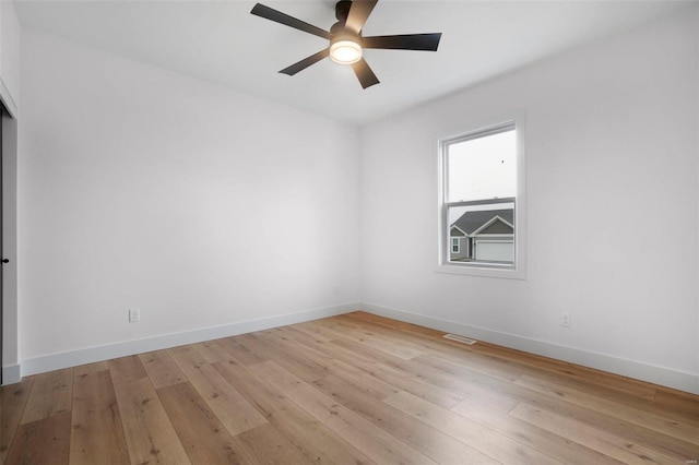 empty room featuring ceiling fan and light wood-type flooring