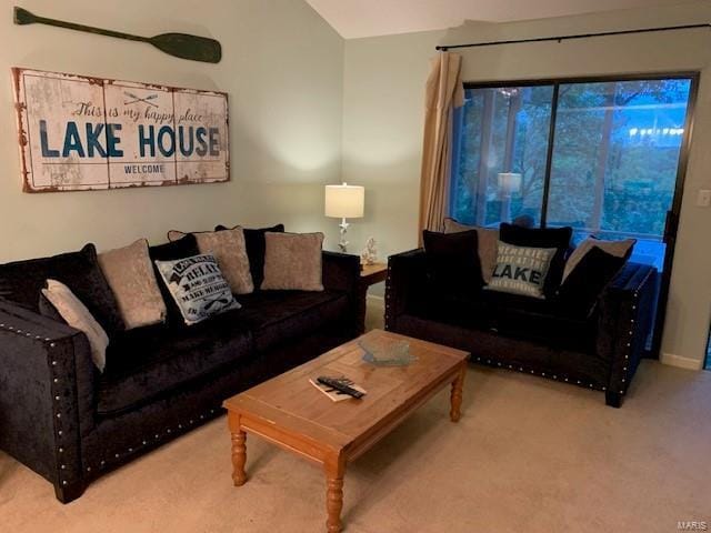 living room with lofted ceiling and carpet flooring