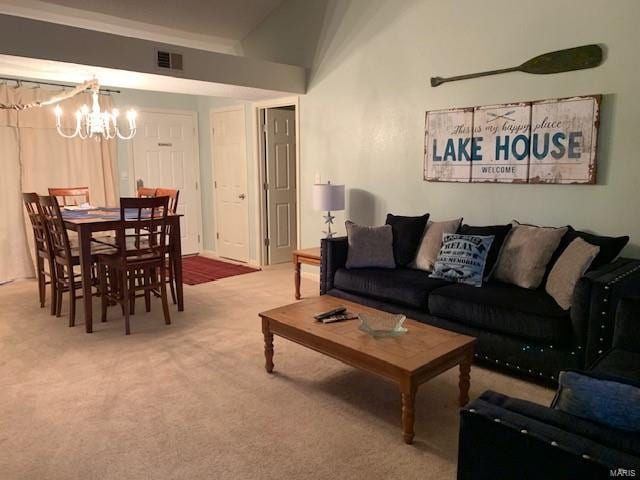 living room featuring lofted ceiling, carpet flooring, and a notable chandelier