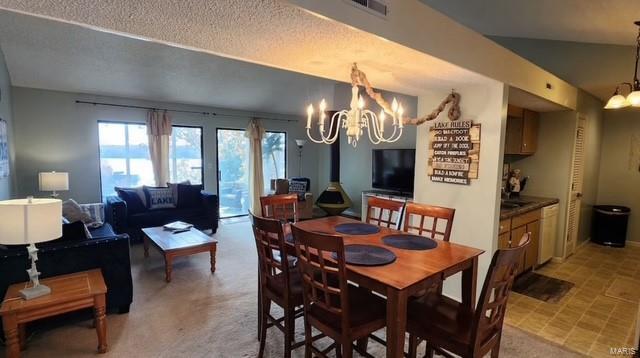 dining area featuring a textured ceiling and a chandelier