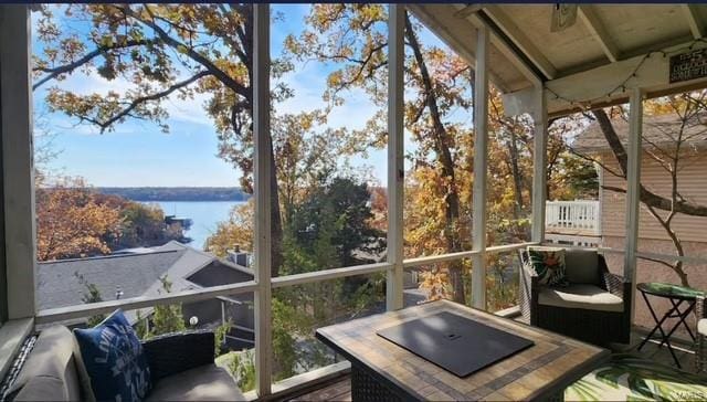 sunroom / solarium with a water view