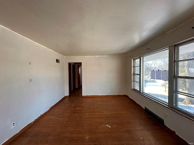 spare room featuring dark hardwood / wood-style floors